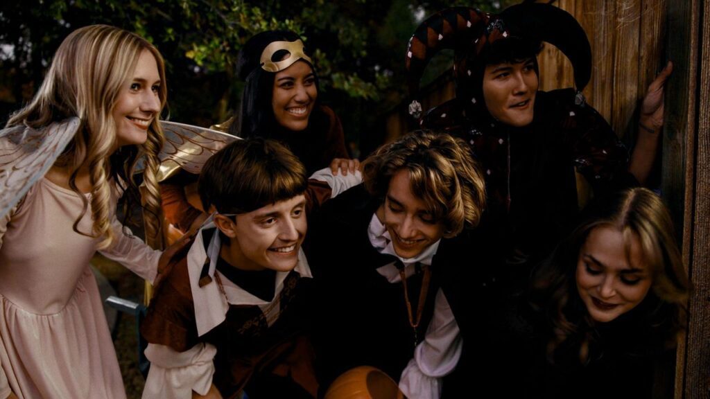 Cast of Hansel & Gretel's Halloween in costume, smiling together on set