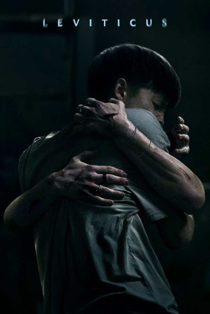 Official poster for Adrian Chiarella’s horror film Leviticus featuring two teenagers embracing amid signs of violence