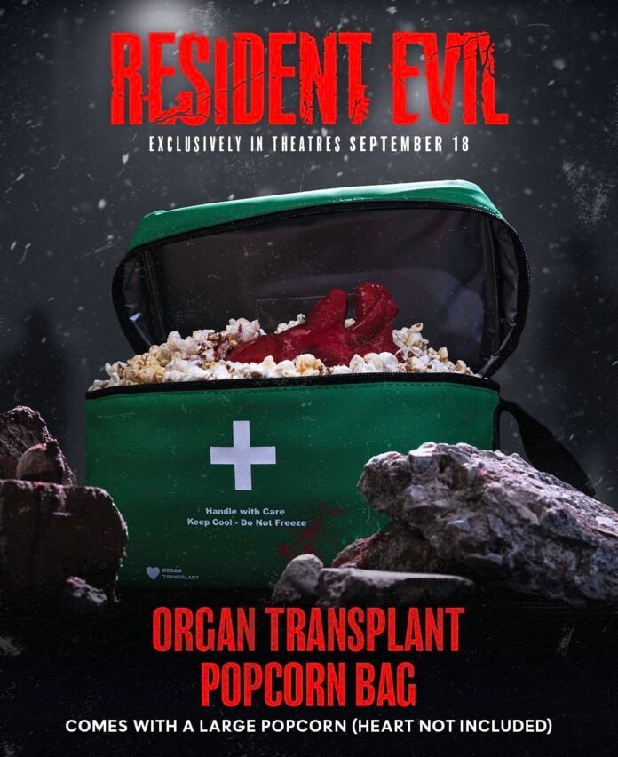 Resident Evil organ transplant popcorn bag filled with popcorn and featuring the movie logo